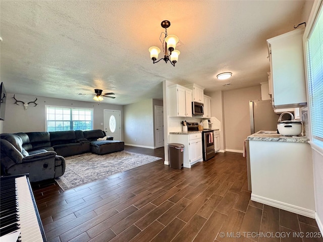 1404 Compelube Rd, Mcalester, OK 74501 - living room featuring ceiling fan, dark wood finished floors, a textured ceiling, and a chandelier