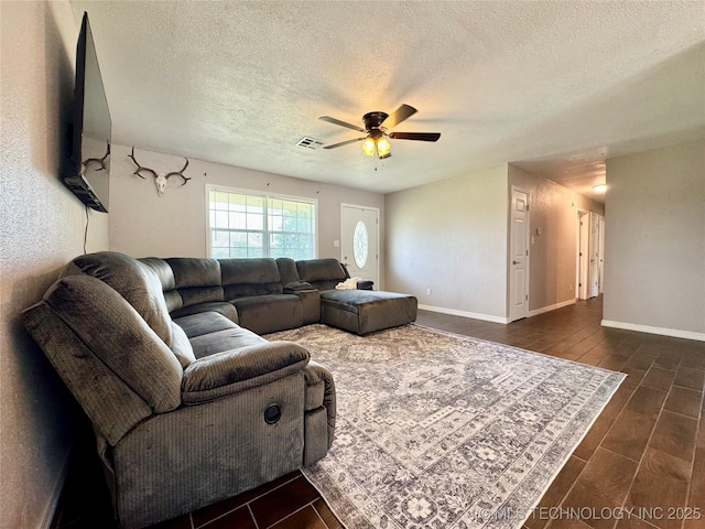 1404 Compelube Rd, Mcalester, OK 74501 - living room with a textured ceiling, ceiling fan, and dark wood-style floors