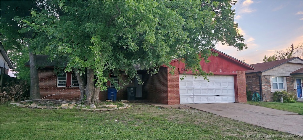 12416 E 15th St S, Tulsa, OK 74128 - view of front of house with a garage, brick siding, concrete driveway, and a lawn