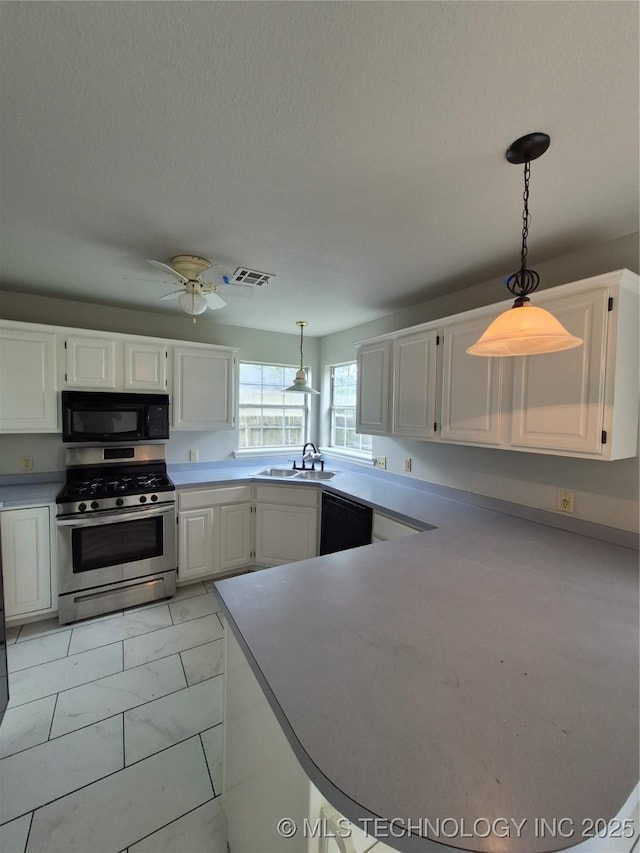 2200 SW Wolf Run Ct, Claremore, OK 74019 - kitchen with black appliances, white cabinetry, hanging light fixtures, and a ceiling fan