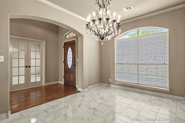 1317 W Dover St, Broken Arrow, OK 74012 - foyer featuring arched walkways, marble finish floors, french doors, crown molding, and a chandelier