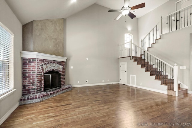 1317 W Dover St, Broken Arrow, OK 74012 - unfurnished living room featuring high vaulted ceiling, a ceiling fan, stairway, plenty of natural light, and wood finished floors