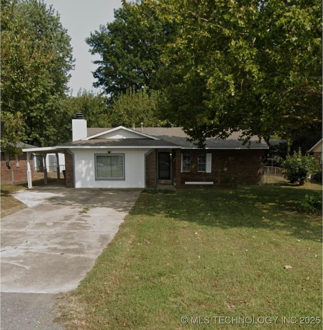 802 N Main St, Wagoner, OK 74467 - ranch-style home featuring concrete driveway, a chimney, and a front lawn