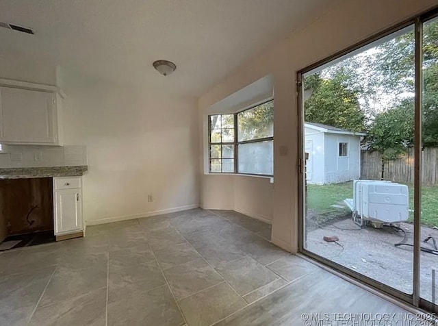 802 N Main St, Wagoner, OK 74467 - unfurnished dining area with baseboards