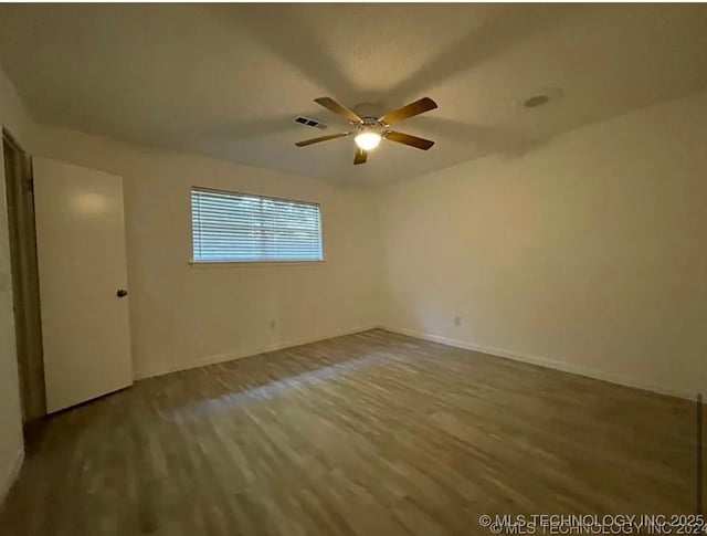 802 N Main St, Wagoner, OK 74467 - empty room with wood finished floors and a ceiling fan