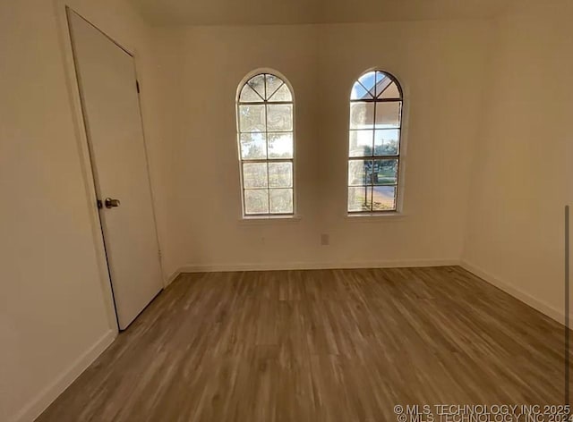 802 N Main St, Wagoner, OK 74467 - empty room with wood finished floors and baseboards