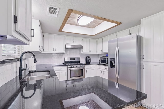 11784 N 154th Ave, Collinsville, OK 74021 - kitchen featuring a tray ceiling, stainless steel appliances, backsplash, and white cabinetry