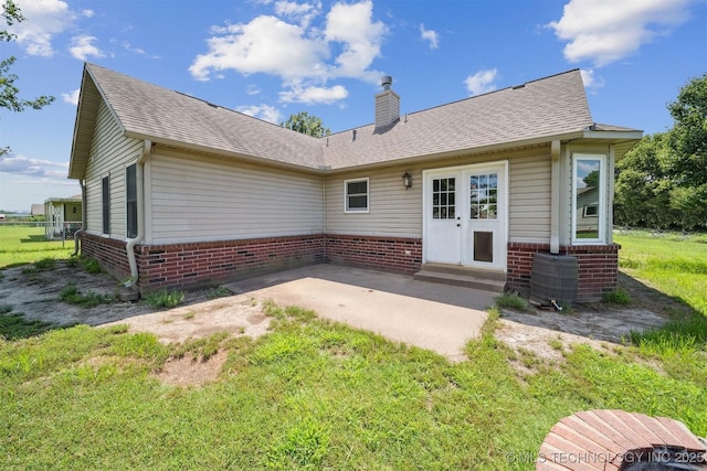 11691 N 193rd E Ave, Collinsville, OK 74021 - back of house featuring brick siding, a chimney, a patio, and a shingled roof