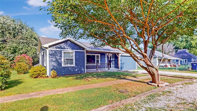 403 N Vine Ave, Cleveland, OK 74020 - view of front of home featuring covered porch and a front lawn
