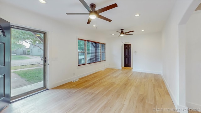 403 N Vine Ave, Cleveland, OK 74020 - empty room featuring a ceiling fan, arched walkways, light wood-style floors, and recessed lighting