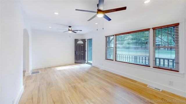 403 N Vine Ave, Cleveland, OK 74020 - unfurnished room with ceiling fan, arched walkways, light wood finished floors, and recessed lighting