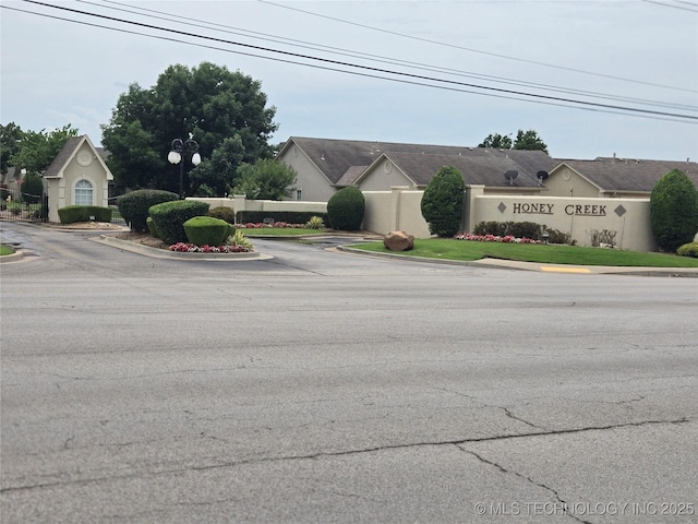 8302 E 84th St, Tulsa, OK 74133 - view of asphalt road featuring curbs and street lights