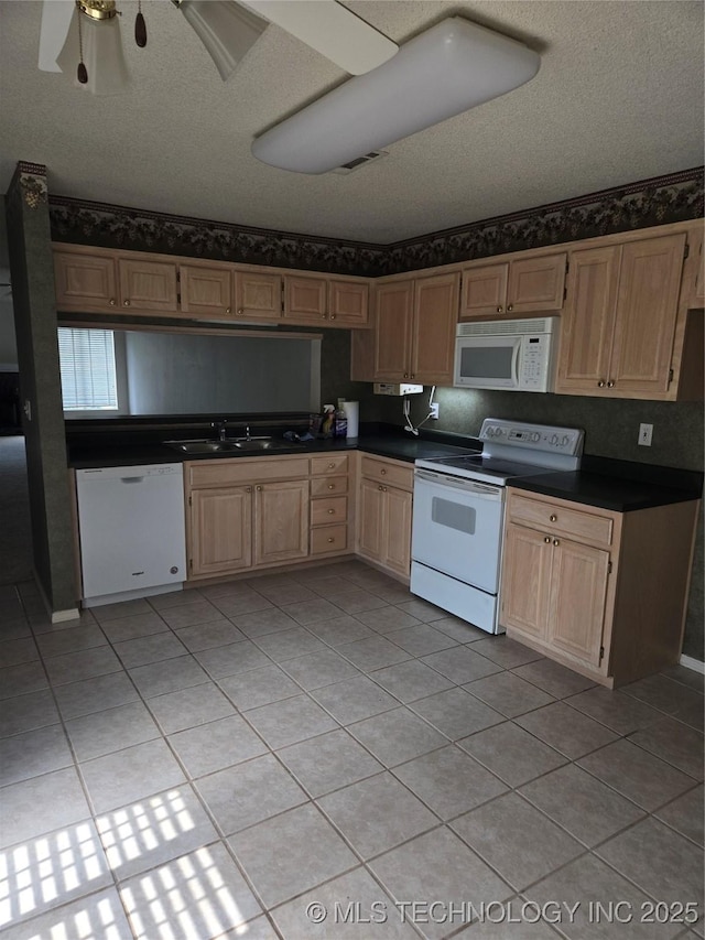 8302 E 84th St, Tulsa, OK 74133 - kitchen with white appliances, light tile patterned floors, dark countertops, light brown cabinets, and a textured ceiling