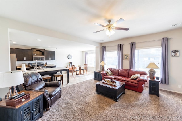 11105 N 145th E Pl, Owasso, OK 74055 - living room featuring light colored carpet, ceiling fan, and recessed lighting