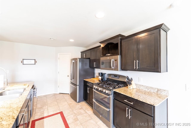 11105 N 145th E Pl, Owasso, OK 74055 - kitchen featuring appliances with stainless steel finishes, dark brown cabinets, light tile patterned flooring, recessed lighting, and light stone counters