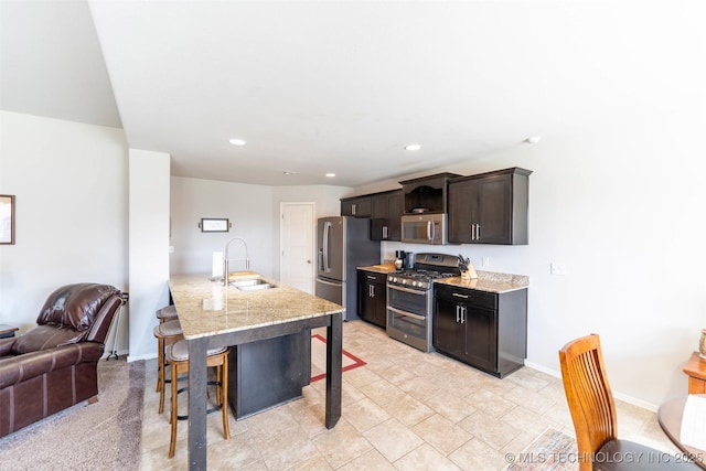 11105 N 145th E Pl, Owasso, OK 74055 - kitchen featuring stainless steel appliances, a breakfast bar, recessed lighting, dark brown cabinets, and open floor plan