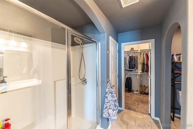 11105 N 145th E Pl, Owasso, OK 74055 - full bath featuring a shower stall, a spacious closet, and tile patterned floors
