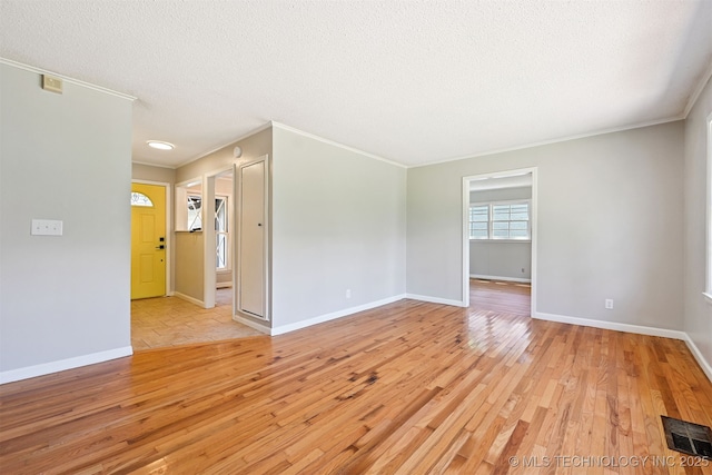 4643 E 59th St, Tulsa, OK 74135 - spare room featuring light wood-type flooring, a textured ceiling, and crown molding