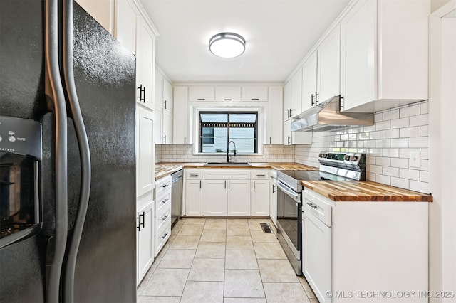 4643 E 59th St, Tulsa, OK 74135 - kitchen with stainless steel appliances, butcher block counters, backsplash, under cabinet range hood, and light tile patterned floors