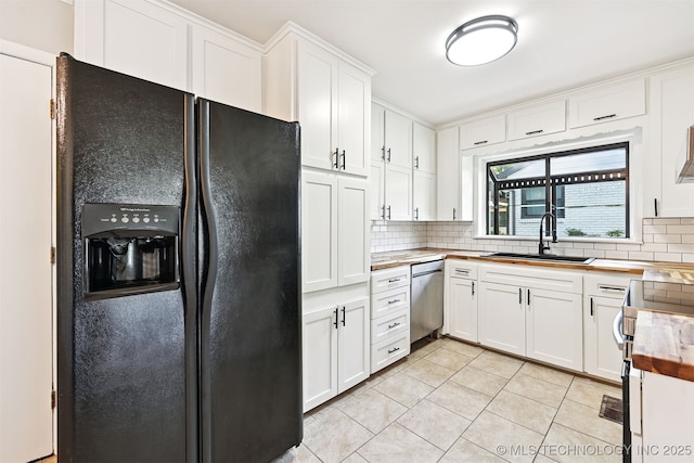 4643 E 59th St, Tulsa, OK 74135 - kitchen featuring stainless steel appliances, decorative backsplash, light tile patterned flooring, and white cabinetry