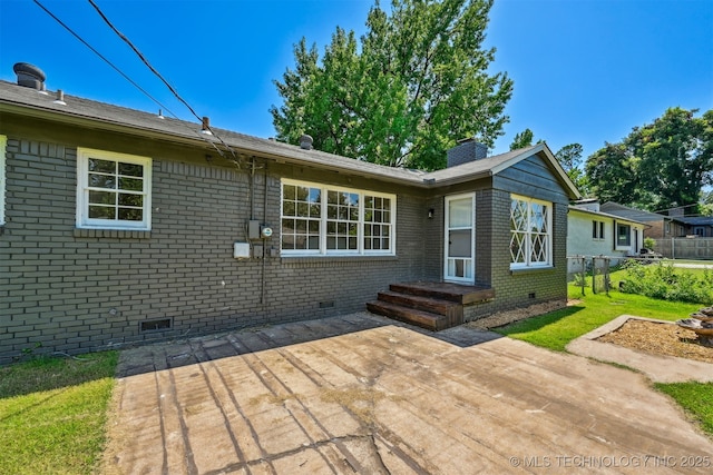 4643 E 59th St, Tulsa, OK 74135 - back of property with crawl space, a patio, brick siding, and a chimney