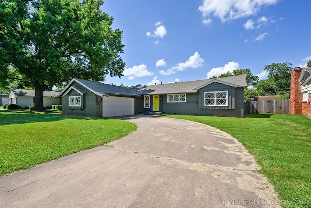 4643 E 59th St, Tulsa, OK 74135 - ranch-style house featuring an attached garage, concrete driveway, and brick siding