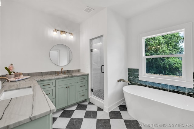 1524 N Main St, Tulsa, OK 74106 - full bath with double vanity, a stall shower, a soaking tub, tile walls, and tile patterned flooring
