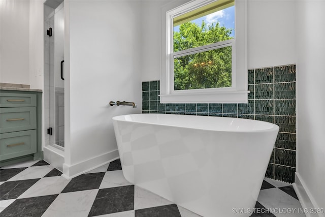 1524 N Main St, Tulsa, OK 74106 - full bath featuring tile walls, a freestanding tub, and a stall shower