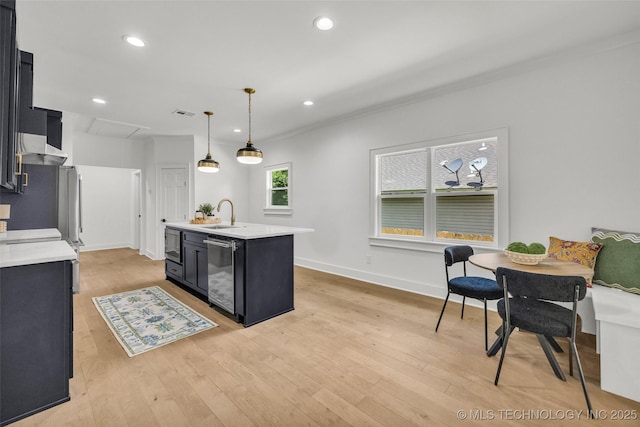 1524 N Main St, Tulsa, OK 74106 - kitchen with appliances with stainless steel finishes, dark cabinetry, light countertops, exhaust hood, and recessed lighting