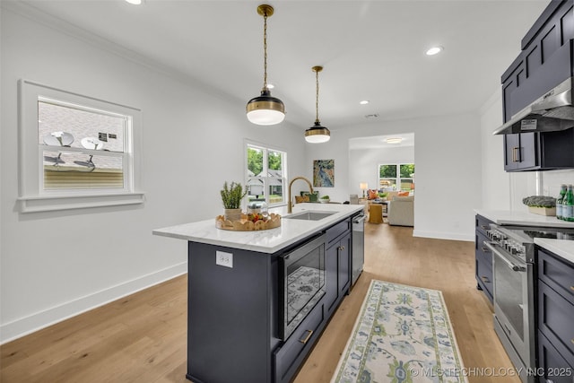 1524 N Main St, Tulsa, OK 74106 - kitchen featuring stainless steel appliances, exhaust hood, recessed lighting, light wood finished floors, and pendant lighting