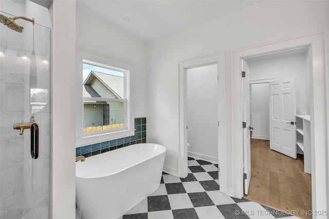 1524 N Main St, Tulsa, OK 74106 - bathroom featuring tile patterned floors, a shower stall, a freestanding bath, and tile walls