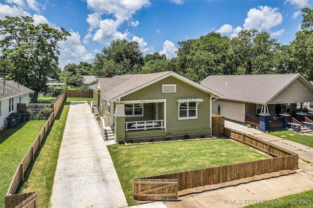1524 N Main St, Tulsa, OK 74106 - bungalow-style home featuring covered porch, a fenced backyard, and a shingled roof