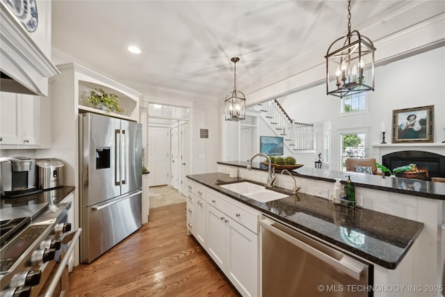 8002 E Galveston Pl, Broken Arrow, OK 74014 - kitchen with appliances with stainless steel finishes, a chandelier, white cabinetry, dark stone countertops, and crown molding