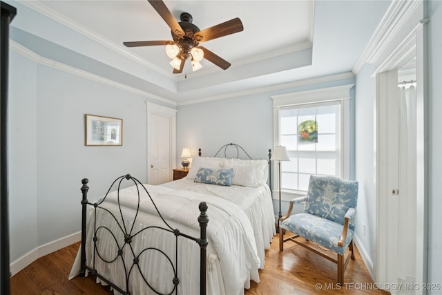 8002 E Galveston Pl, Broken Arrow, OK 74014 - bedroom featuring wood finished floors, a raised ceiling, crown molding, and ceiling fan