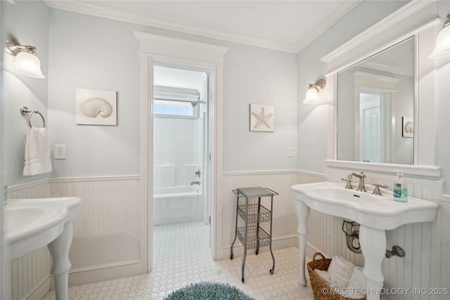 8002 E Galveston Pl, Broken Arrow, OK 74014 - bathroom featuring a wainscoted wall, a bathtub, and ornamental molding