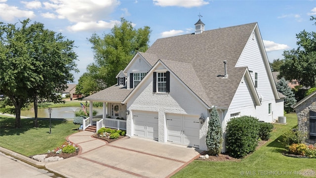 8002 E Galveston Pl, Broken Arrow, OK 74014 - traditional-style house with a porch, a water view, a front yard, driveway, and a shingled roof