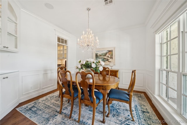 8002 E Galveston Pl, Broken Arrow, OK 74014 - dining room with healthy amount of natural light, crown molding, wood finished floors, a decorative wall, and a chandelier