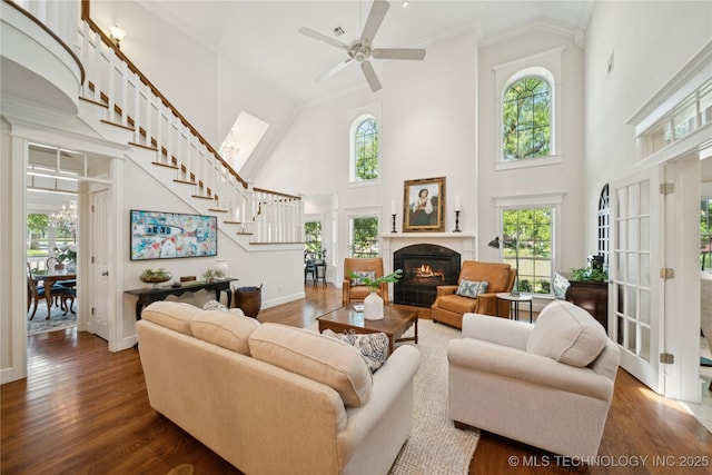 8002 E Galveston Pl, Broken Arrow, OK 74014 - living area with high vaulted ceiling, stairway, wood finished floors, a ceiling fan, and crown molding