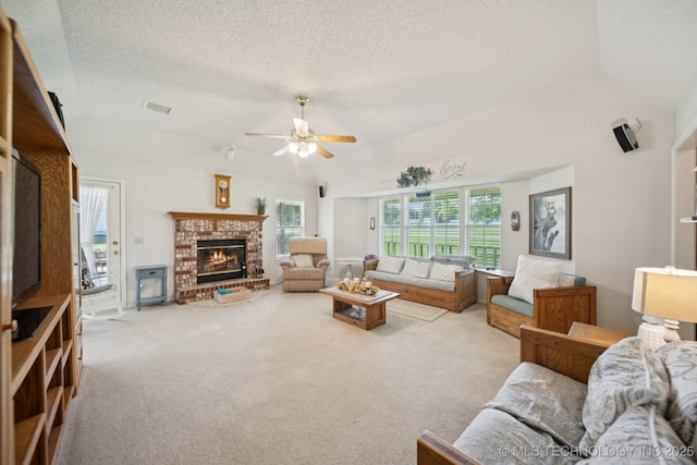 5621 E Hunter Ln, Claremore, OK 74019 - living room featuring a brick fireplace, ceiling fan, a textured ceiling, carpet, and vaulted ceiling