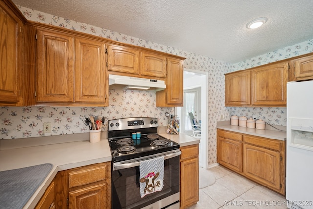 5621 E Hunter Ln, Claremore, OK 74019 - kitchen featuring stainless steel electric stove, under cabinet range hood, white refrigerator with ice dispenser, wallpapered walls, and light countertops