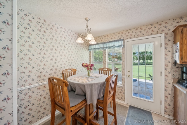 5621 E Hunter Ln, Claremore, OK 74019 - dining room featuring wallpapered walls, a chandelier, and a textured ceiling