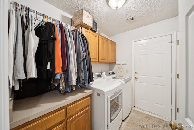 5621 E Hunter Ln, Claremore, OK 74019 - washroom with separate washer and dryer, cabinet space, and a textured ceiling