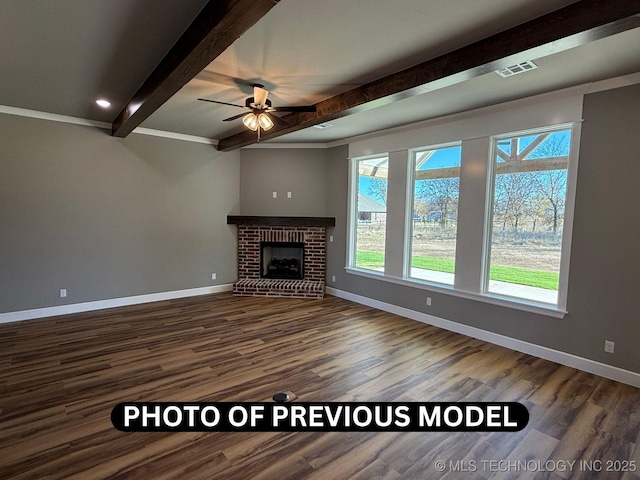 7010 E 137th St, Collinsville, OK 74021 - unfurnished living room with beamed ceiling, wood finished floors, ceiling fan, and a brick fireplace