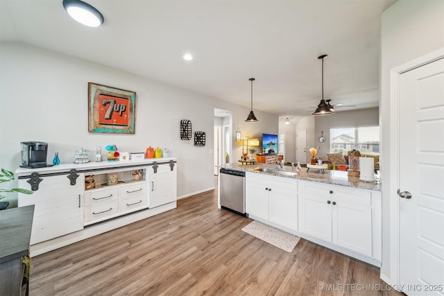 1111 W Cheyenne Ln, Claremore, OK 74019 - kitchen featuring dishwasher, a ceiling fan, light wood finished floors, white cabinets, and open floor plan