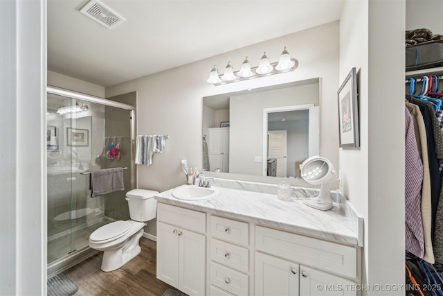 1111 W Cheyenne Ln, Claremore, OK 74019 - bathroom with vanity, a shower stall, and wood finished floors