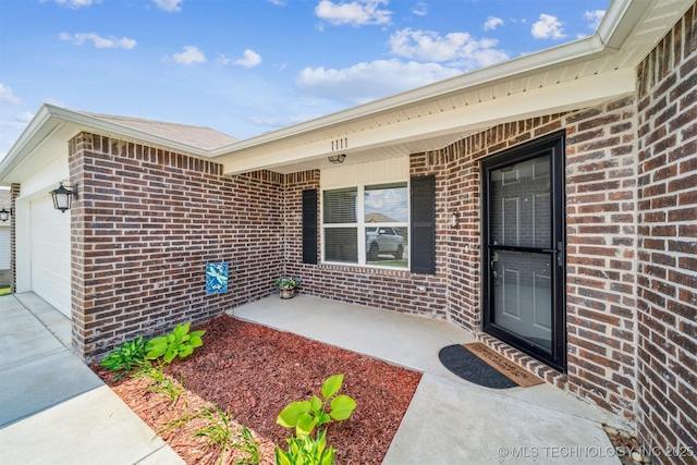 1111 W Cheyenne Ln, Claremore, OK 74019 - entrance to property featuring a garage, brick siding, a porch, and driveway