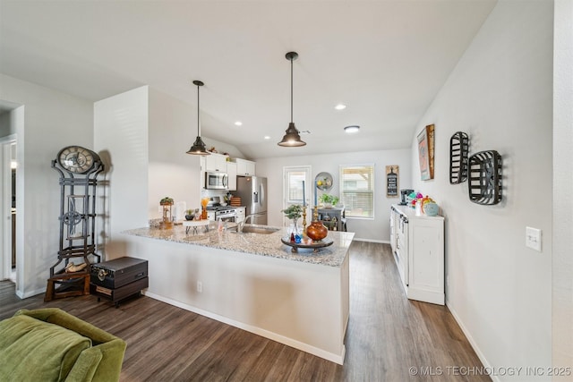 1111 W Cheyenne Ln, Claremore, OK 74019 - kitchen with stainless steel appliances, white cabinets, a peninsula, dark wood-style floors, and recessed lighting