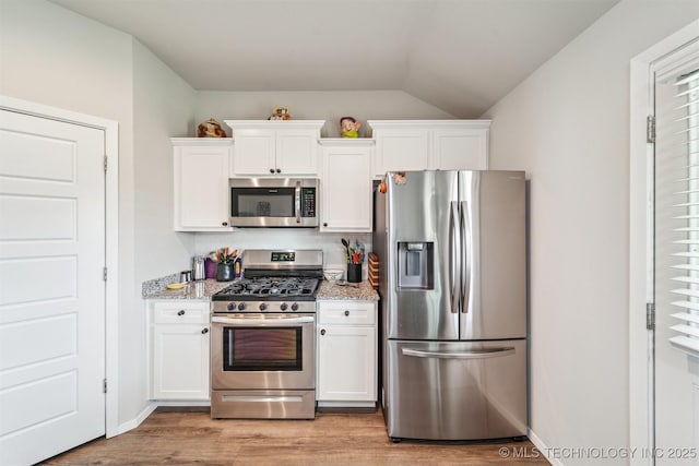 1111 W Cheyenne Ln, Claremore, OK 74019 - kitchen with appliances with stainless steel finishes, white cabinetry, light stone countertops, and lofted ceiling