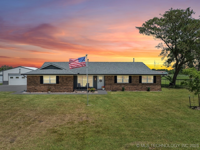 1120 S Sequoyah Dr, Oologah, OK 74053 - ranch-style house with a shingled roof, brick siding, and a garage