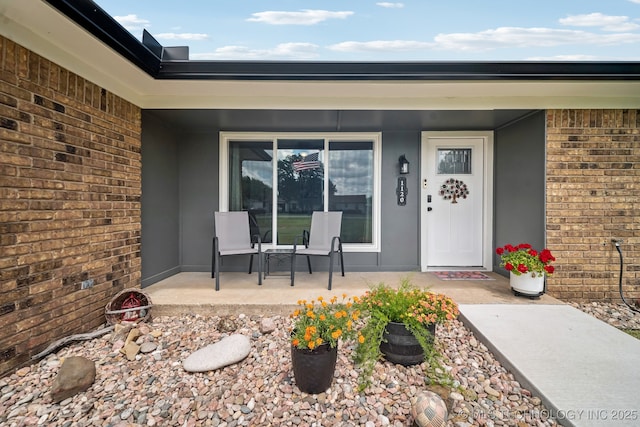 1120 S Sequoyah Dr, Oologah, OK 74053 - property entrance with a porch, stucco siding, and brick siding